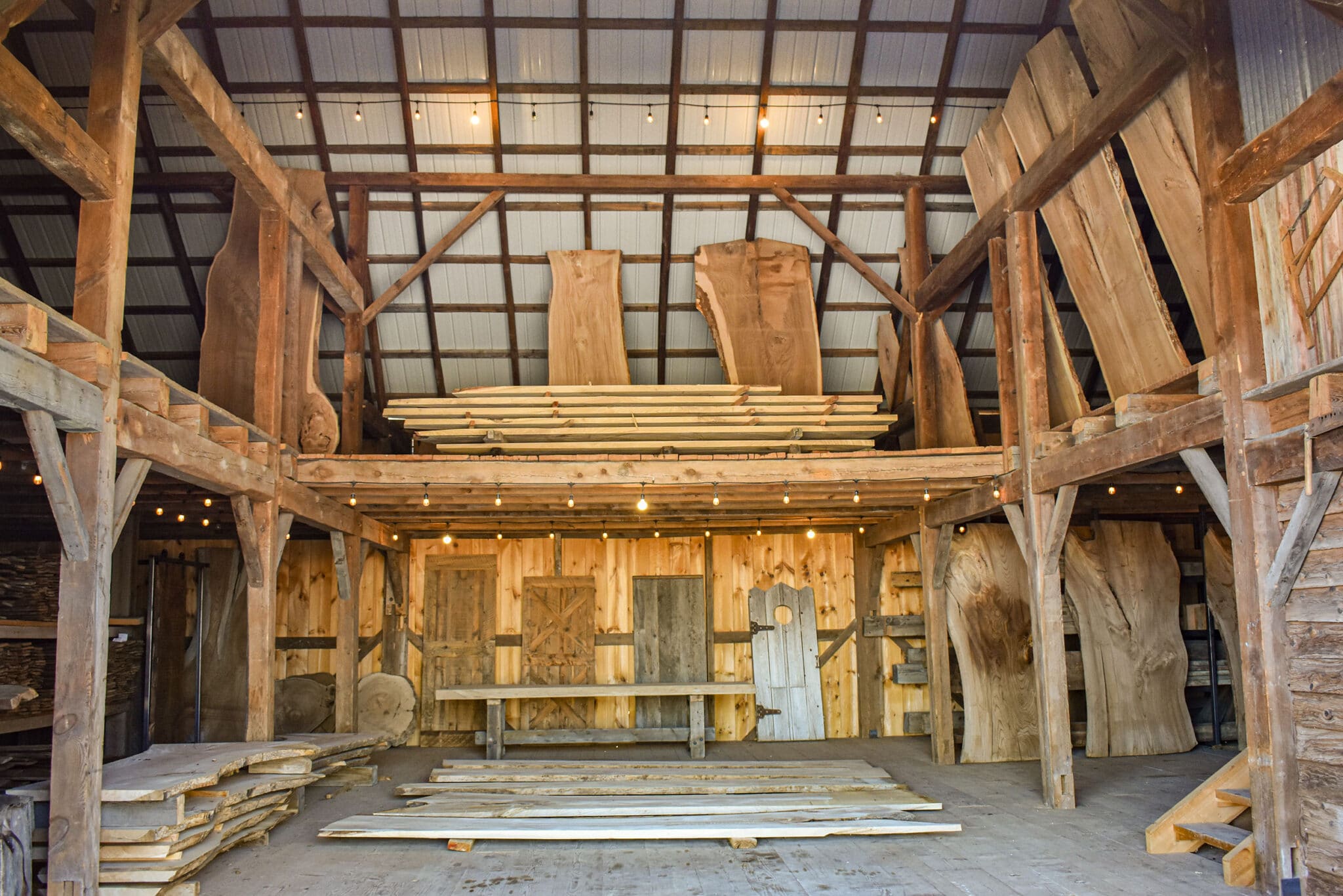 Barn in Idaho filled with reclaimed lumber and beams and live edge slabs